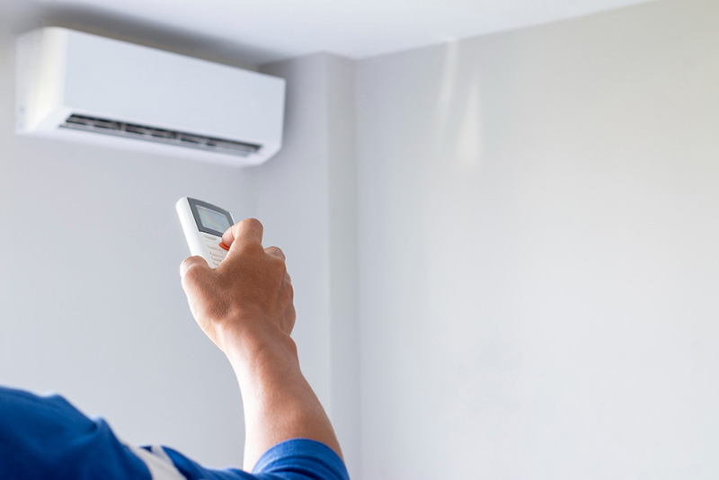 close-up-man-hand-operating-air-conditioner-with-remote-control (1)